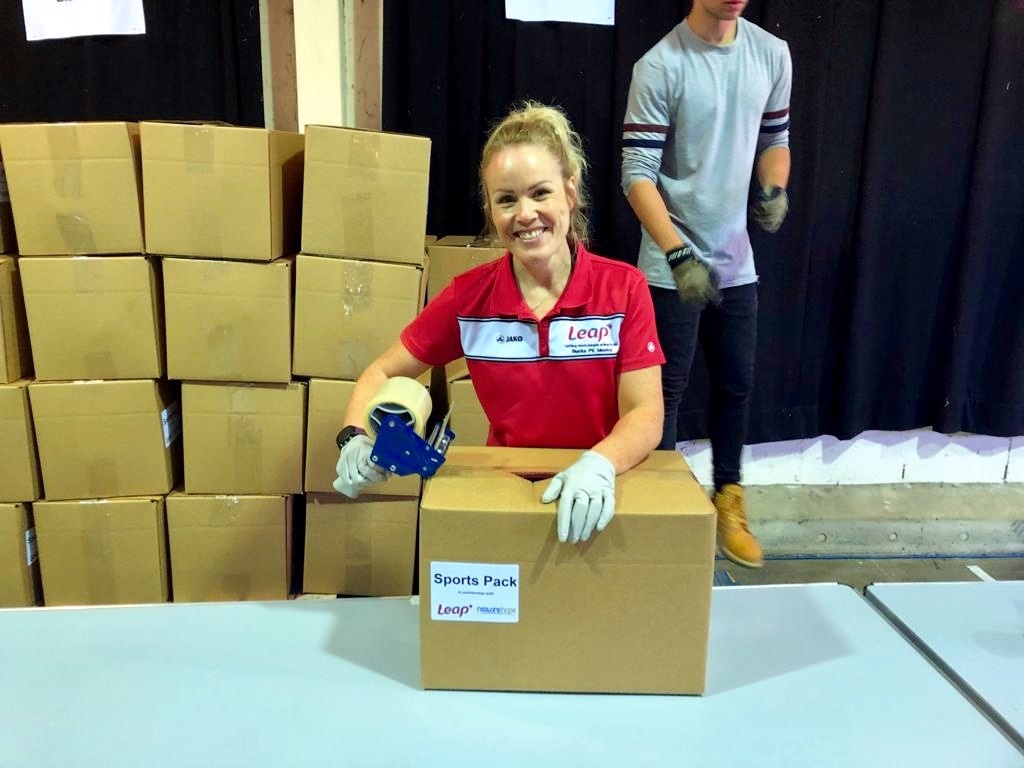 Leap member of staff packing boxes