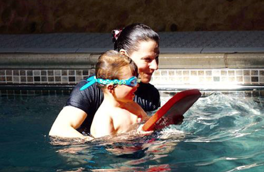 Sarah helping Seb learn to swim