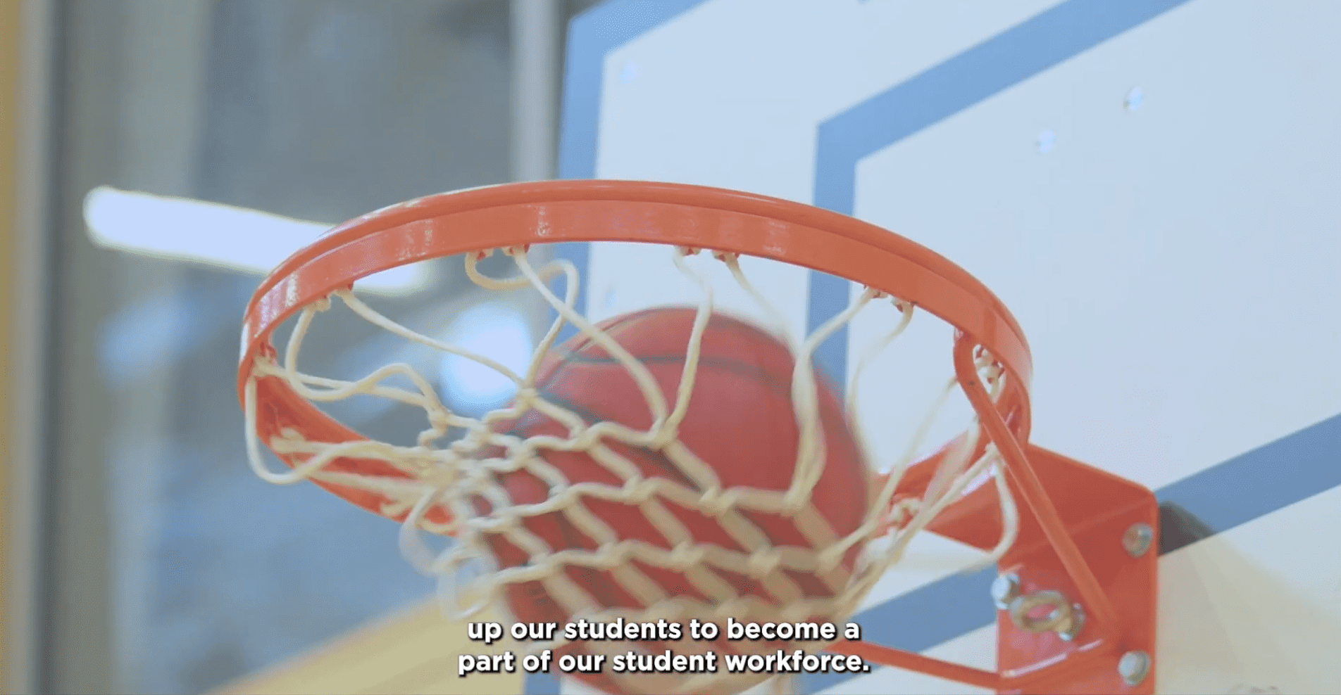 basketball going through a hoop in indoor hall