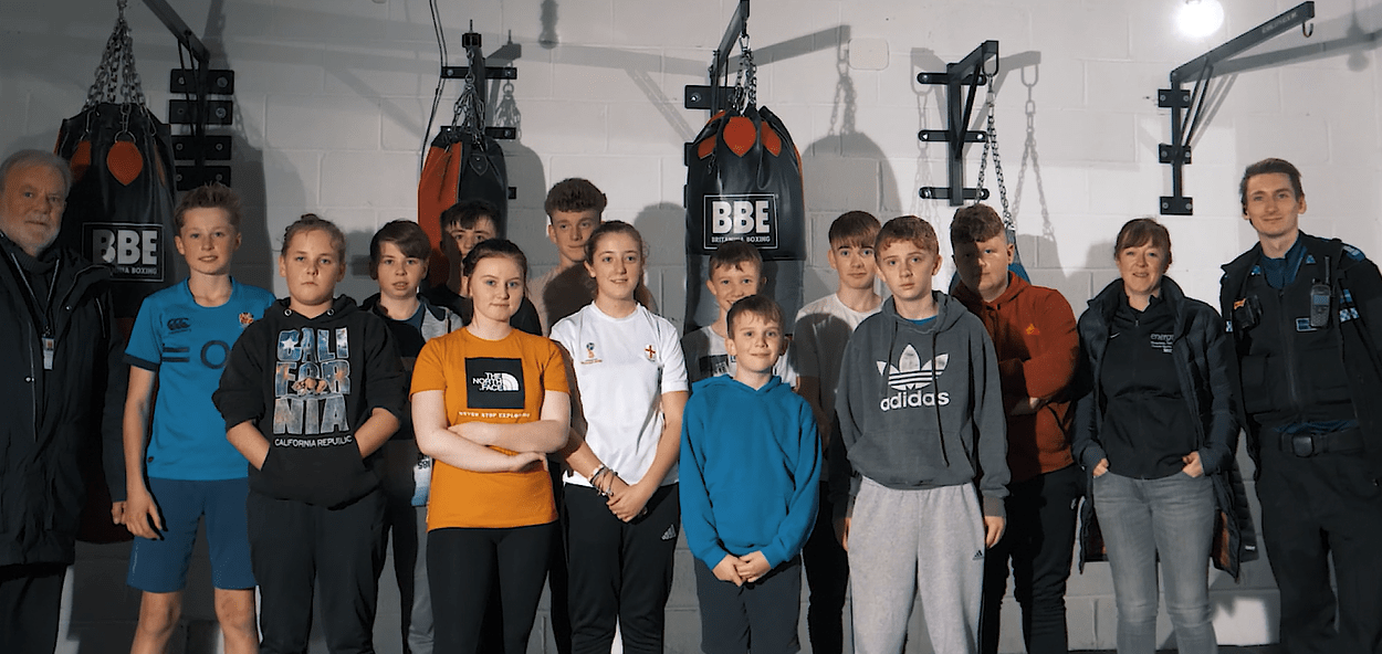 group image of participants involved in boxing sessions and police officer