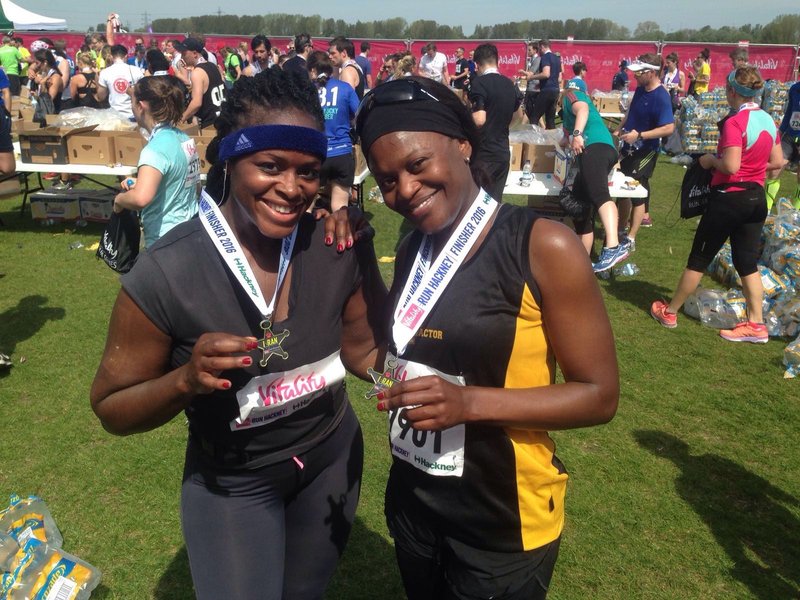 Two female participants with their athletic medals