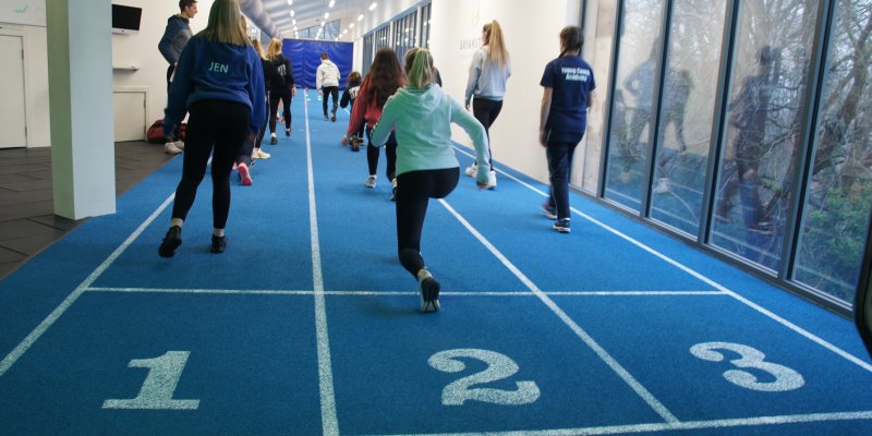 Young leaders involved in athletics warm up