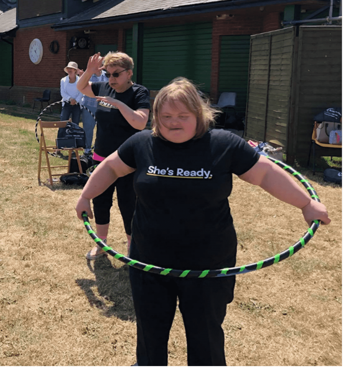 Female hula hooping in an outdoor space 