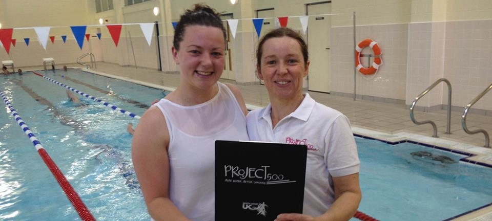 female swimming coaches standing by pool