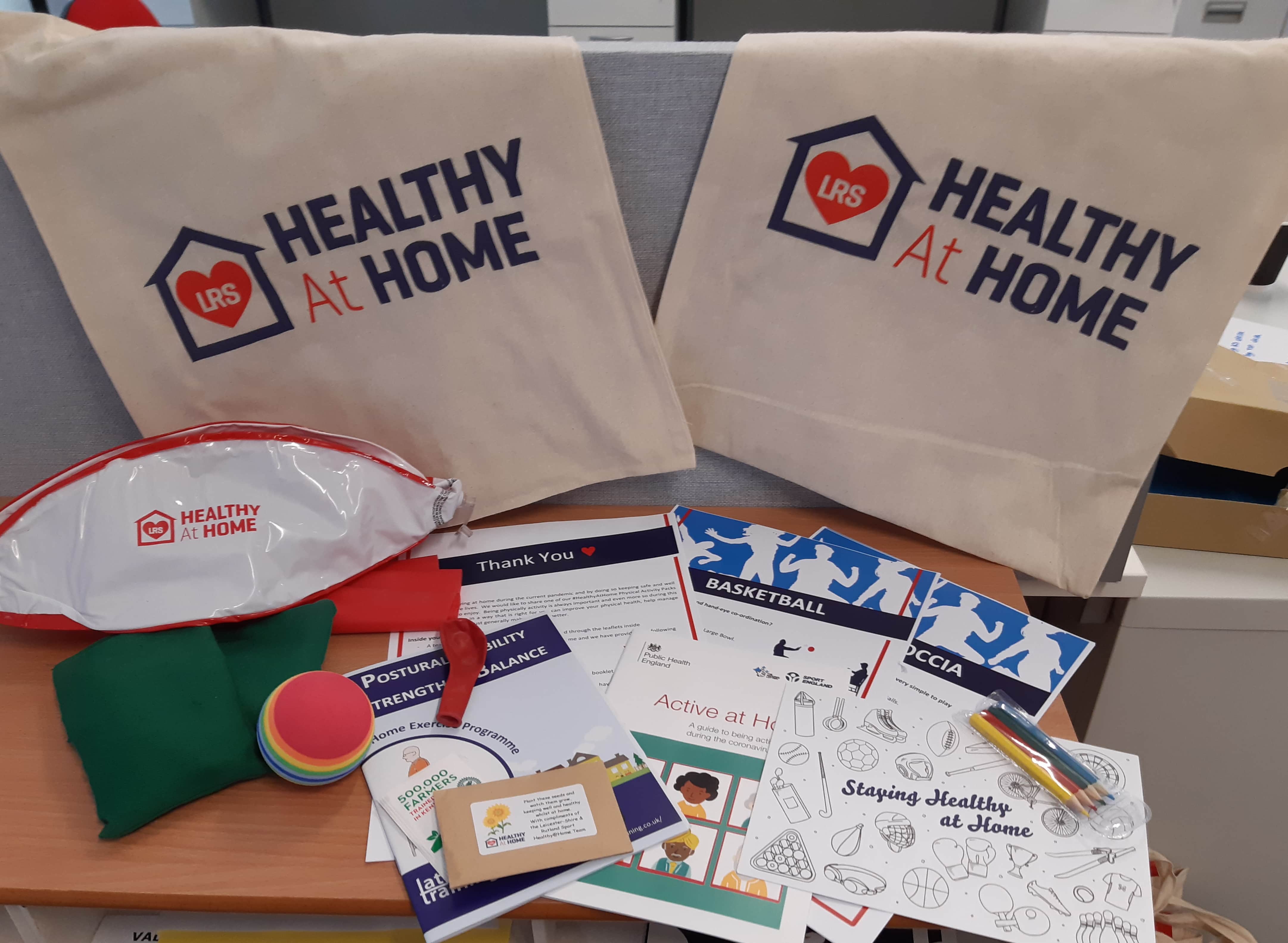 Contents of healthy at home packs including balls, bean bags, activity cards