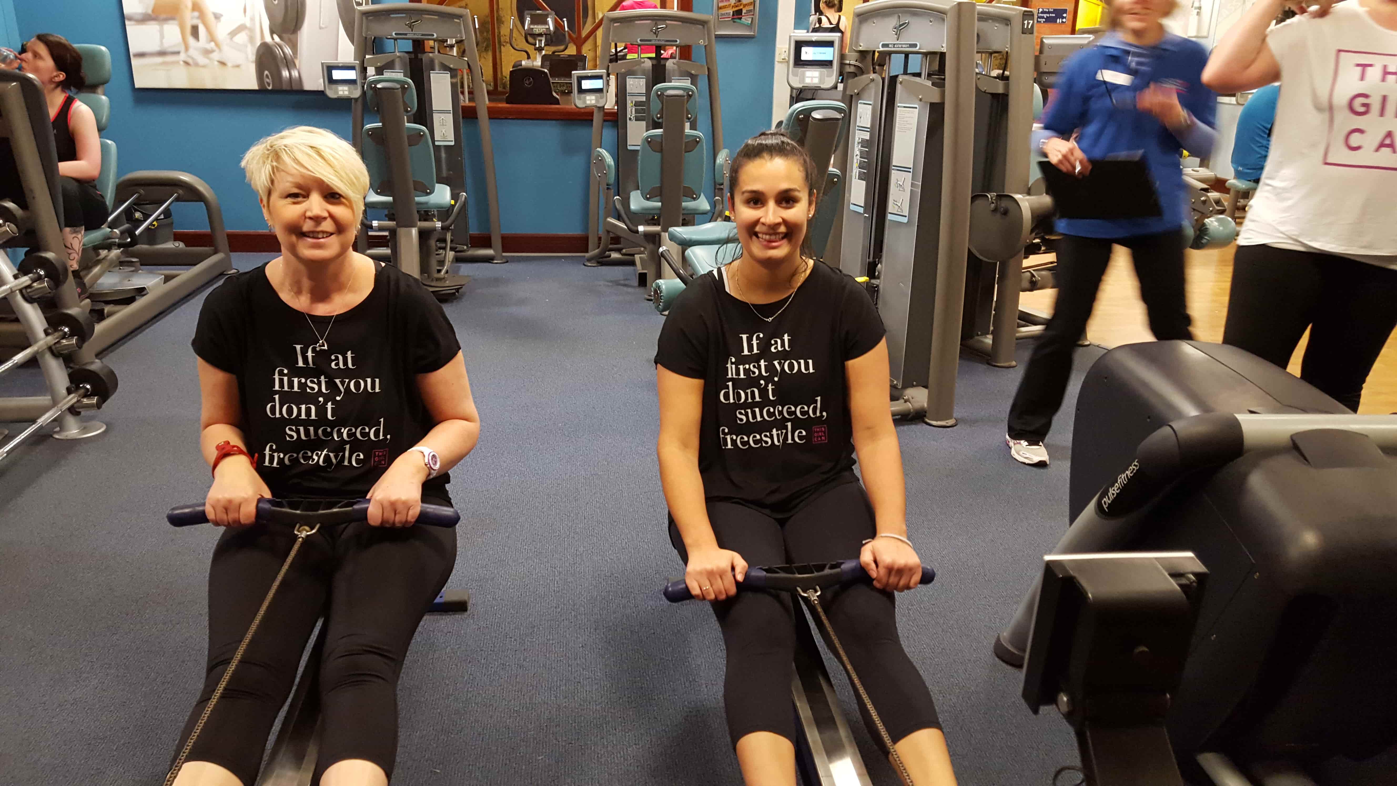 two females using rowing machines