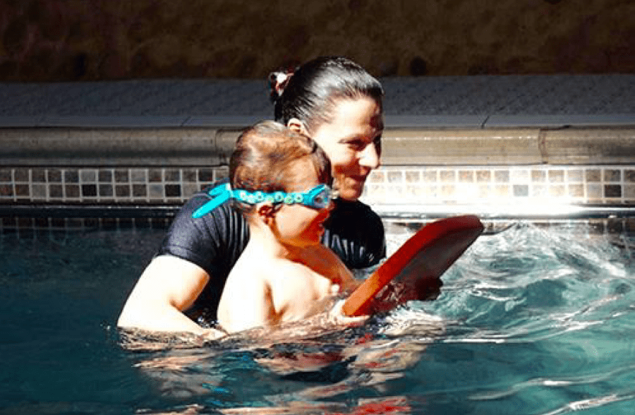 Sarah helping Seb learn to swim
