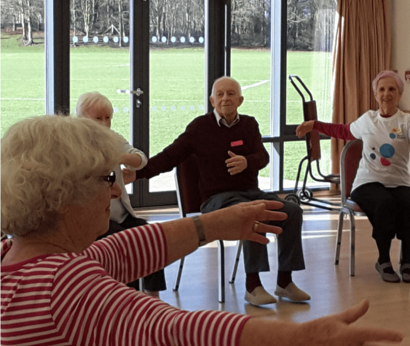 people taking part in arm chair dance sessions