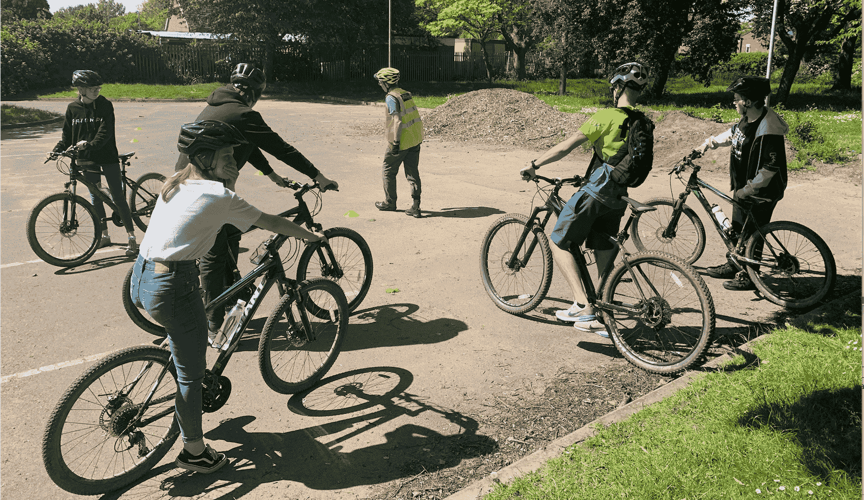 group of cyclists being taught some skills