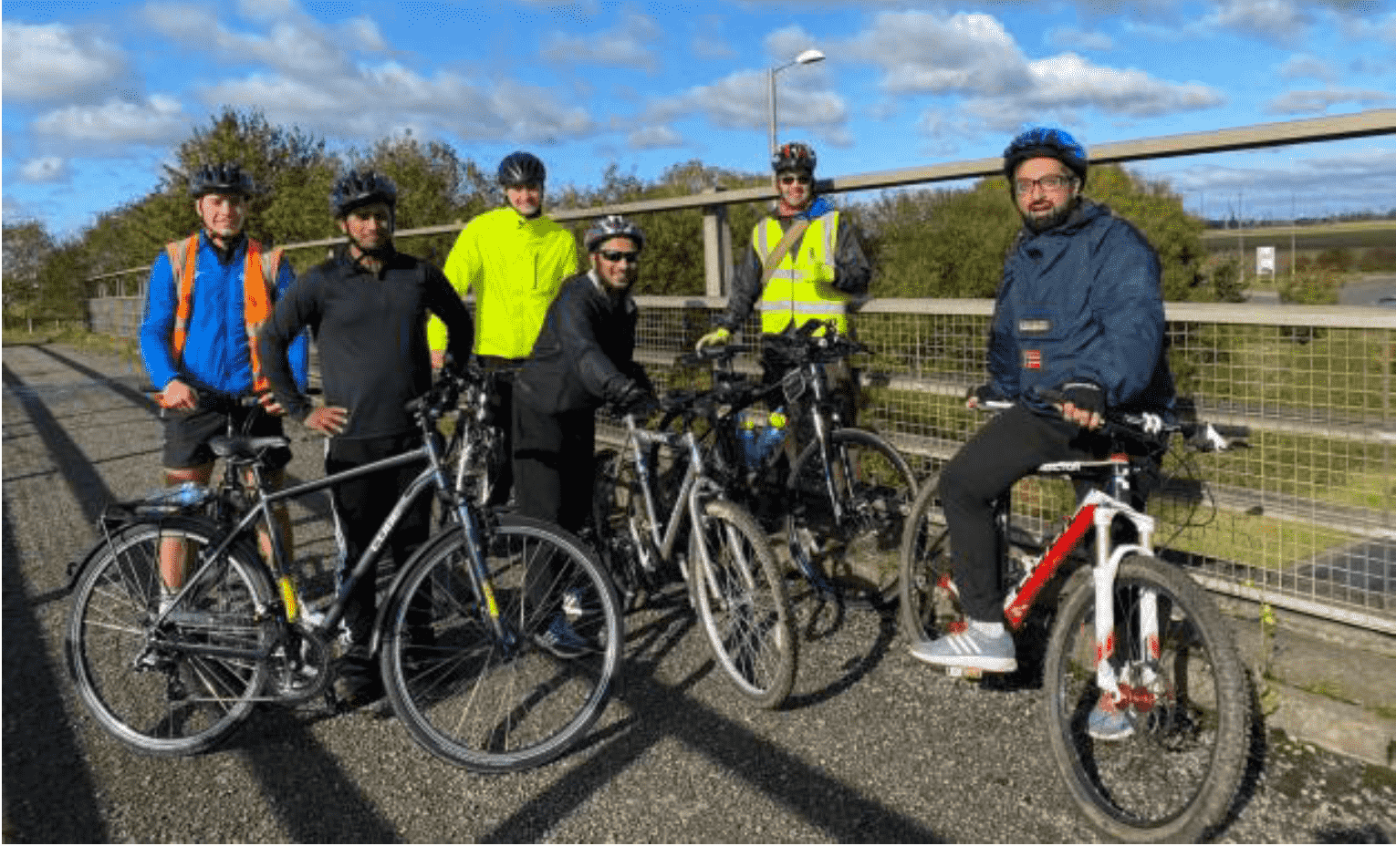 Group of cyclists from the project stopped on a bridge during group ride