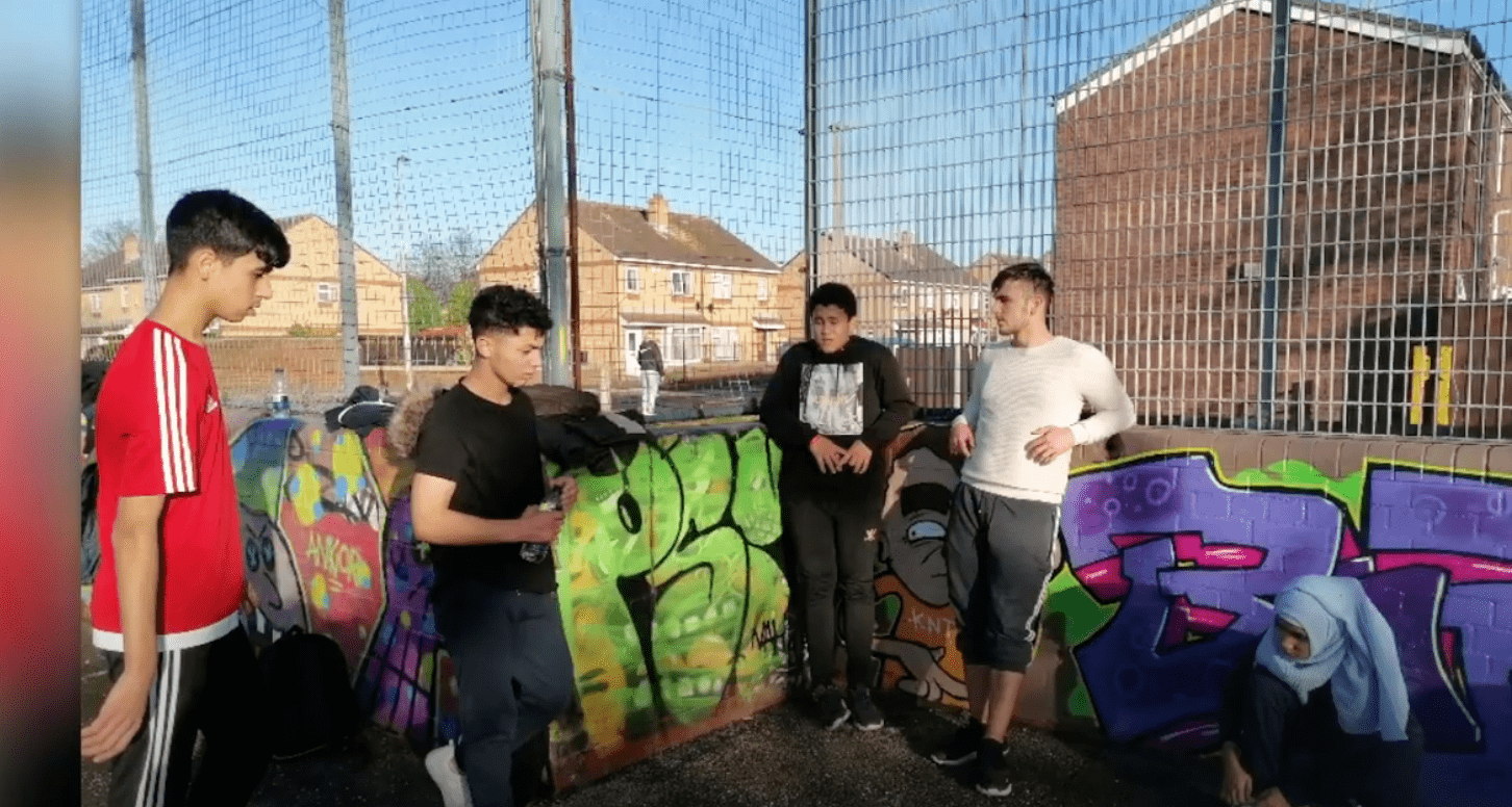 4 teenagers in a graffiti basketball court 