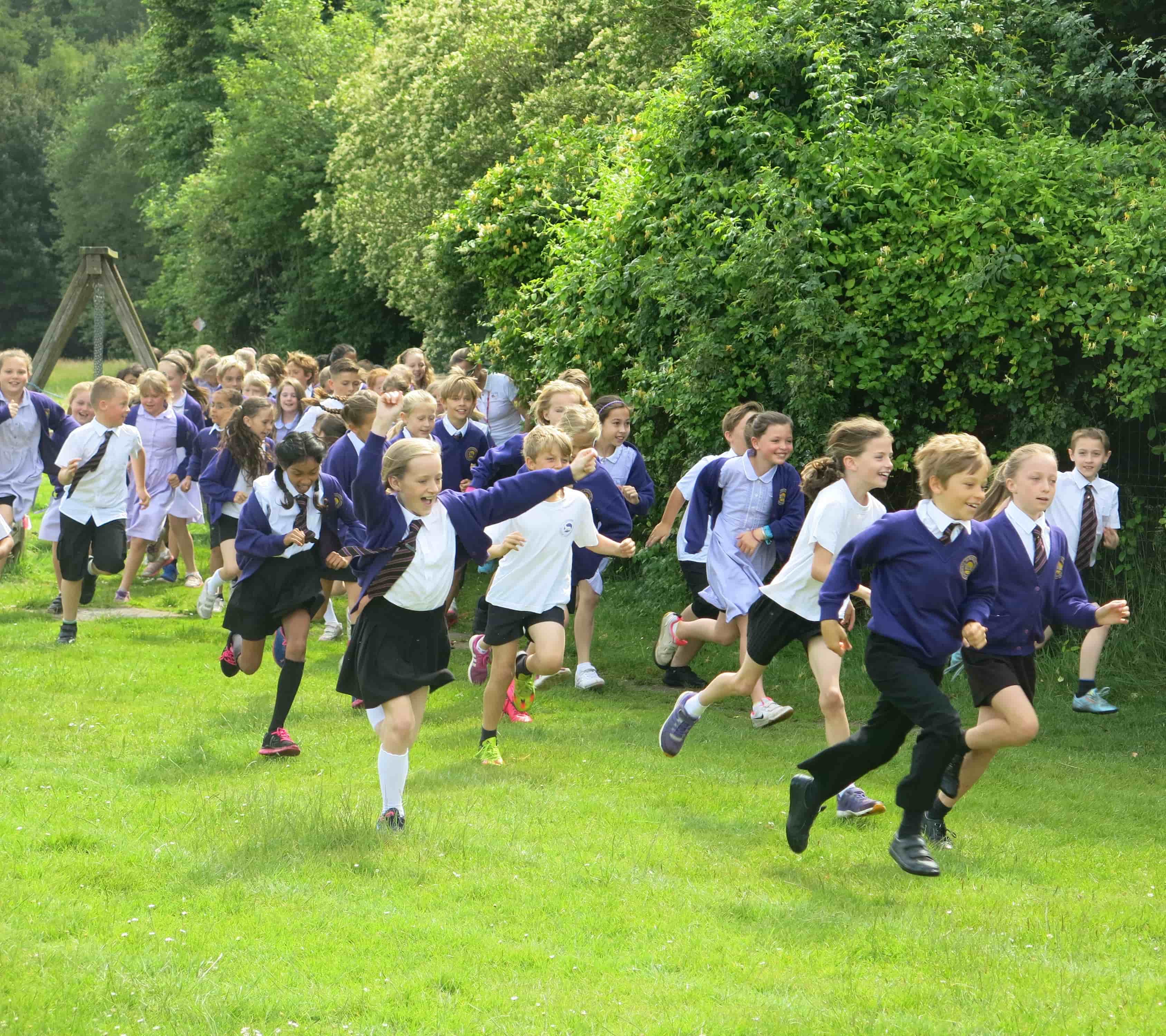 Children enjoying running around school field