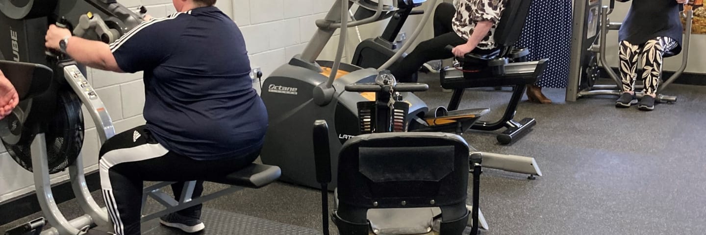 female on a seated exercise machine in a gym