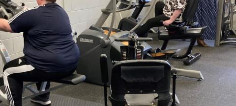female on a seated exercise machine in a gym