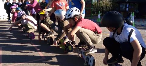group of children with their skateboards in the playground