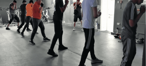 group of asian teenagers taking part in boxing session