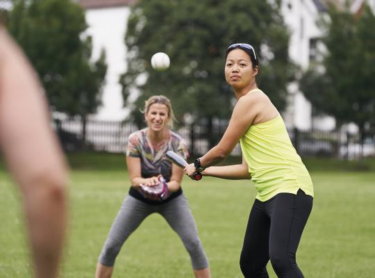 women playing rounders in the park
