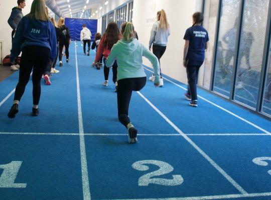 Young leaders involved in athletics warm up