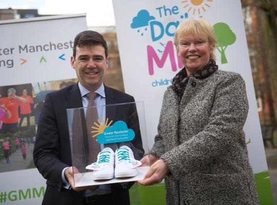 Eliane Wyllie presenting Andy Burham with special pair of ‘The Daily Mile’ plimsolls