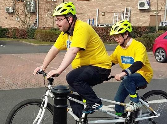 Ben and son cycling on a tandem 