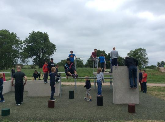 Children learn how to navigate the parkour obstacles at Hadleigh Park