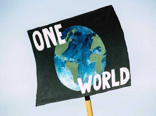 image off globe one a black background with the words ' One world'