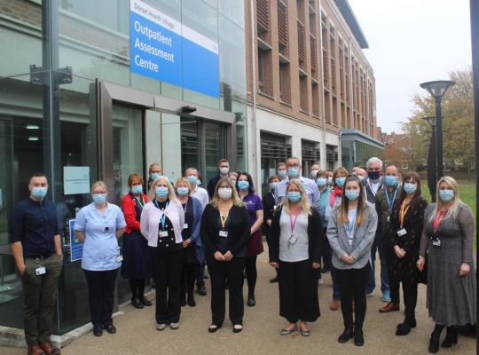 workers standing outsides new outpatients centre